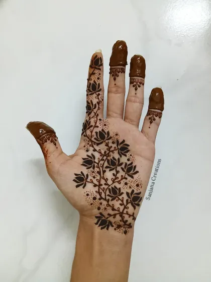 A beautiful Indo-western design featuring a vine of lotus flowers. The filled fingertips add a traditional touch to this modern pattern.