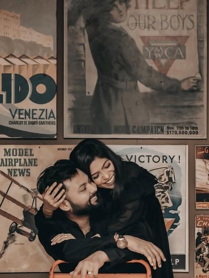 A fun, retro-themed pre-wedding shot. The makeup is classic and timeless, fitting the vintage poster background perfectly.