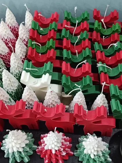 A wide shot of my Christmas collection, including tree candles, reindeer, and snowflake designs.