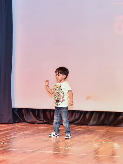 Yuvaan captured in motion during his stage debut, showing his natural rhythm.