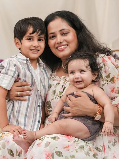 A beautiful portrait of a mother with her two children, capturing a moment of quiet connection and love.