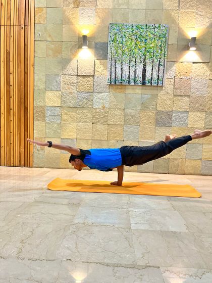 Another angle of the One-Handed Peacock Pose. This asana is a powerful demonstration of wrist strength, core control, and unwavering focus.