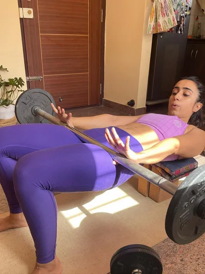 Mid-rep during a home-based hip thrust, focusing on form and control. Proper technique is something we prioritize in every session, regardless of location.