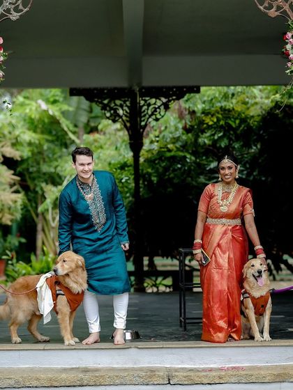 A heartwarming photo of the couple with their beloved golden retrievers, who were part of their special day.