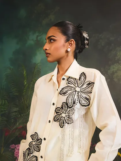 The Azalea Co-Ord Set in ivory, embodying contemporary elegance and luxury with its artistic floral embellishments and modern silhouette.