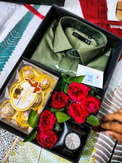 A romantic gift hamper for Valentine's Day, including a smart green shirt, a watch, Ferrero Rocher truffles, and red roses.