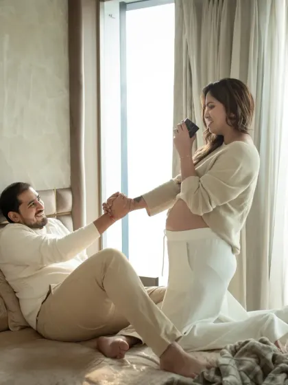A playful, candid moment on the bed, filled with laughter and movement. These lifestyle shots capture the real, unscripted joy of your pregnancy journey.