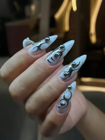A side view of the futuristic metallic 3D nail art, showing the dimension and structure of the design. These are perfect for making a bold statement.