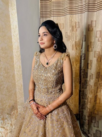 A candid side profile, showing the soft waves in her hair and the natural-looking makeup.