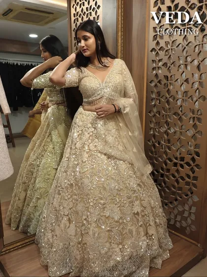 This cream and gold lehenga is pure royalty. The heavy floral embroidery makes it perfect for a bridal or reception look.