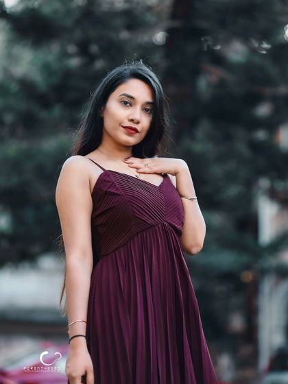 A simple and elegant three-quarter portrait. Her direct gaze and gentle smile are warm and engaging.