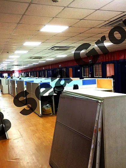 The interior of a large prefabricated office shelter, fully fitted with cubicles, lighting, and flooring. We deliver ready-to-use office environments that can accommodate a large workforce.