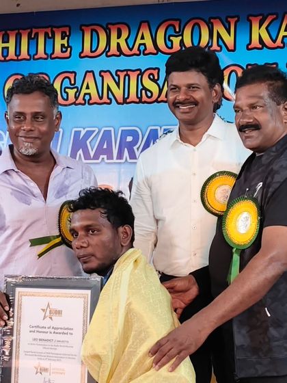 A moment of honor, receiving an award and certificate of appreciation at the White Dragon Karate Do event.