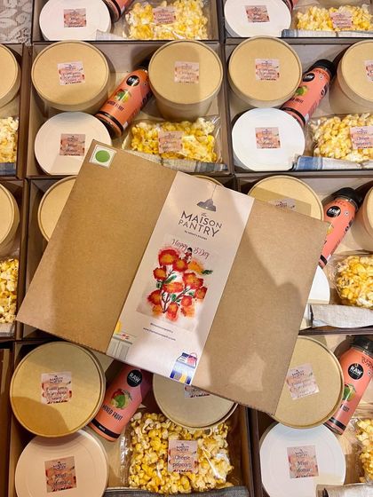 I love adding a personal touch. This image shows a custom-themed sleeve being placed on a party box, showcasing how I can tailor the packaging to match your party's theme.