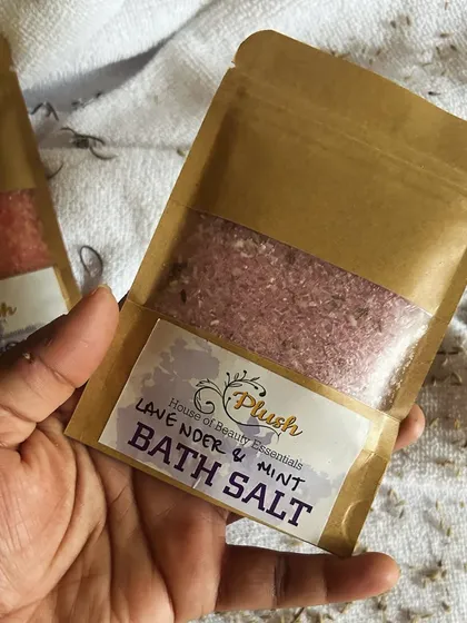 Holding a packet of my Lavender & Mint bath salt. The simple, eco-friendly packaging lets the quality of the product inside shine through.