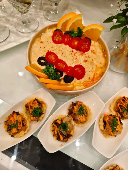 Dippin’ into delicious! This creamy, cheesy dip is finished with vibrant cherry tomatoes, olives, and citrus, making every chip a celebration.