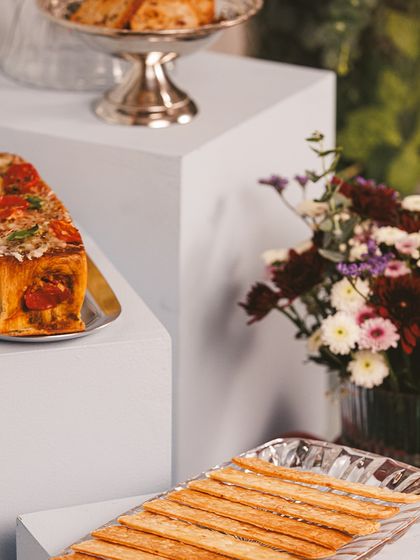 Indulge in the choicest flavours this Diwali with our gourmet savouries. This spread features a pesto and cherry tomato croissant loaf alongside buttery cheese crackers.