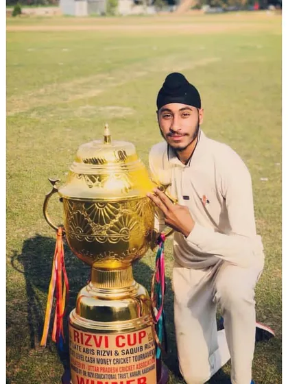 A young player from our academy posing with the Rizvi Cup. We nurture talent from a young age, preparing them for future success.