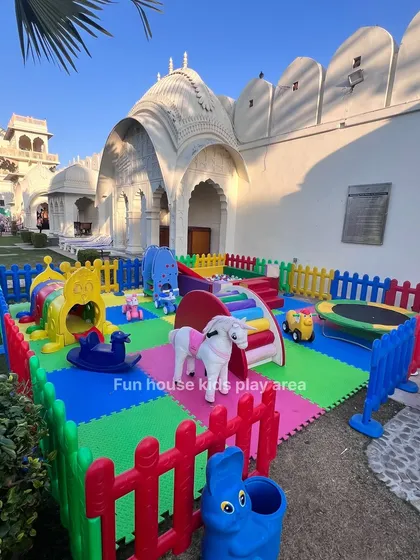 We can set up a vibrant play zone anywhere, like this beautiful outdoor space at a resort. Our rainbow-themed play area includes a trampoline, slide, rockers, and a tunnel, ensuring there's an activity for every child.