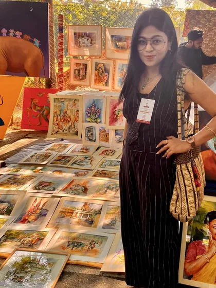 Me at my booth during Chitra Santhe 2024, one of Bangalore's biggest art fairs. I sold 14 paintings that day, and my heart was full of gratitude for all the love and support.