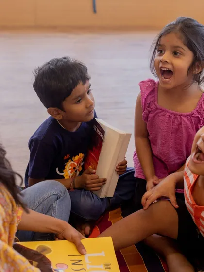 The joy of a shared story. We use engaging books like 'The Lion Inside' to teach valuable lessons about courage and self-acceptance in a fun, interactive group setting.