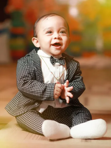 Dressed up in a dapper suit and bow tie, this little gentleman is all smiles. A pre-birthday shoot is a great chance to capture your child in adorable, formal outfits.