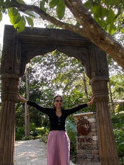 A participant standing at the beautiful wooden gate of our retreat center, Oneness. The entrance itself feels like a portal into a world of nature and tranquility.