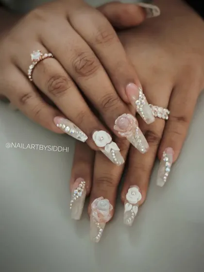 For the ultimate bridal glamour, I created this set featuring long coffin-shaped extensions, delicate 3D acrylic flowers, and a full cascade of Swarovski crystals. This is a showstopper look for any major celebration.