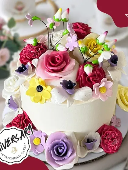 A vibrant floral anniversary cake, bursting with colorful sugar flowers. This "garden of love" is a beautiful way to celebrate a special journey together.