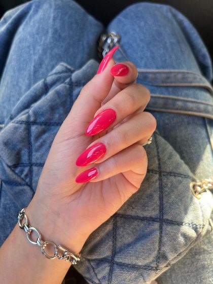 Another shot of this eye-catching magenta manicure. The high-gloss finish and perfect shaping highlight the quality of the service.