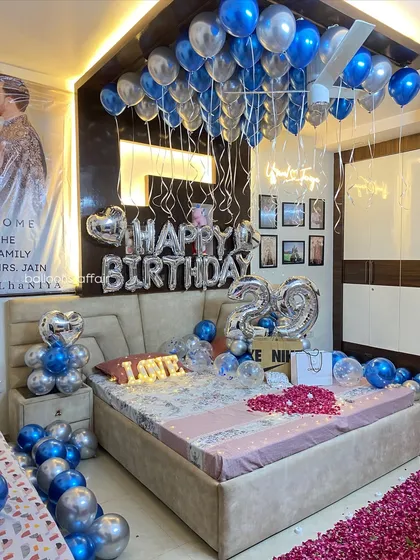 A full view of the blue and silver themed birthday room, showing how all the elements from the floor petals to the ceiling balloons come together.