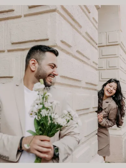 A playful moment of hide-and-seek against the charming architecture of South Mumbai. We look for these candid opportunities to capture your unique chemistry and genuine laughter.