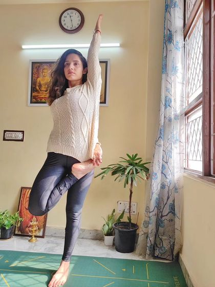 Balancing asanas, like this variation of tree pose, are essential for improving focus. They require you to be fully present, connecting your mind and breath to find stillness.