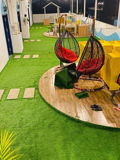 We handled this large rooftop cafe project, using our commercial-grade artificial grass to create a durable and inviting atmosphere for guests. The installation includes custom shaping around seating areas and wooden decks.
