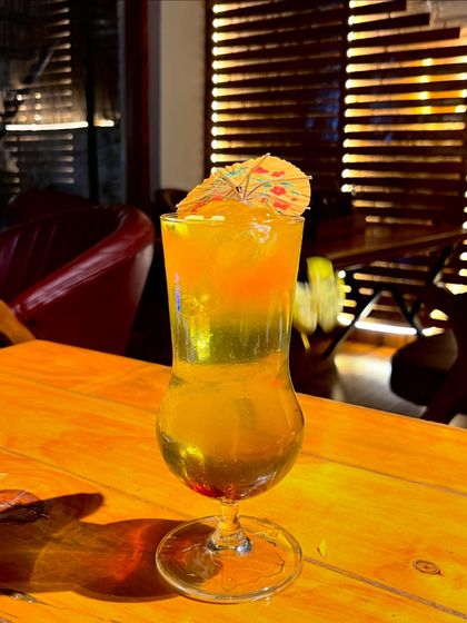 A refreshing orange mocktail, perfect for sipping by the pool.