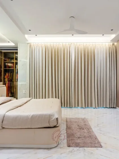 This shot shows the full expanse of the room, including the floor-to-ceiling curtains and the heart-shaped gold console table. It’s a space designed for both rest and sophisticated living.