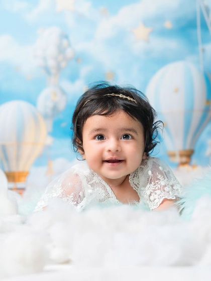 Cuteness overload, straight from the clouds. This baby girl's happy smile makes this dreamy, sky-themed milestone session absolutely magical.