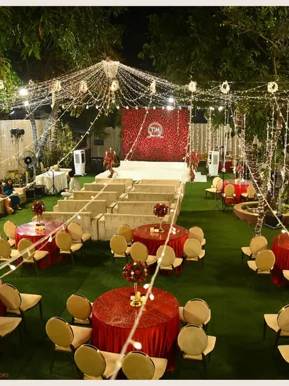 An overview of a red and gold themed games night. The space is filled with fairy lights and elegant table settings, creating a warm and inviting atmosphere for an evening of fun.