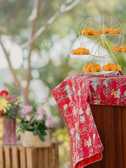 A mini Ferris wheel holding marigold ladoos was one of the playful details at our 'Rajasthani Folklore' Mehendi. It’s these little whimsical touches that make an event memorable.