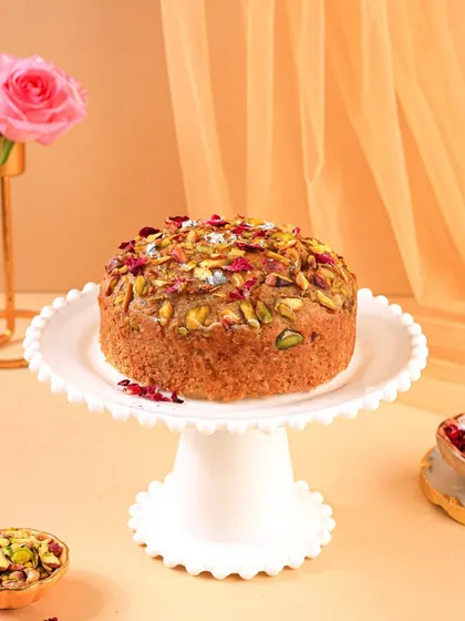 The same beautiful Mawa cake, this time on a classic cake stand. This angle gives it a more traditional and celebratory feel, perfect for a special occasion.