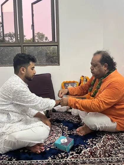 Receiving the sacred thread from my Guru during the 2023 Guru Purnima.