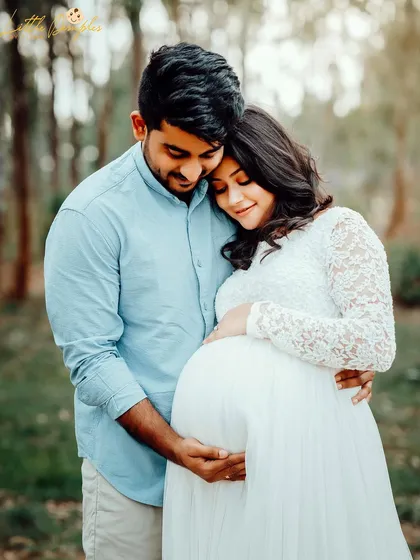 This portrait captures the loving embrace of an expecting couple during their outdoor photoshoot, surrounded by the beauty of nature.