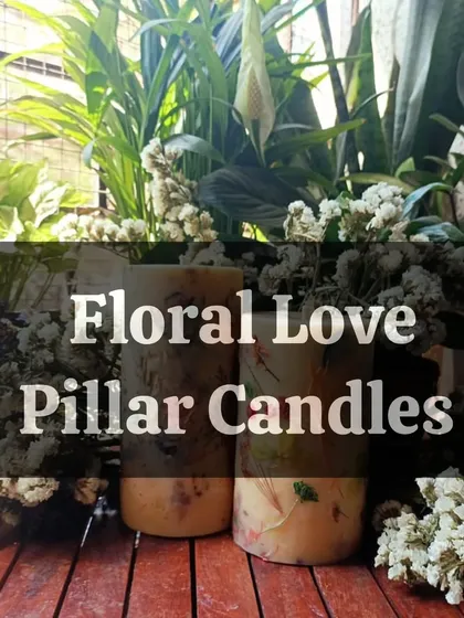 A title card for our Floral Love Pillar Candles, showcasing their beauty against a backdrop of flowers. These are perfect for those who appreciate both candles and flowers.