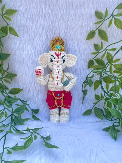 A detailed look at my Lord Ganesh doll. I carefully stitched the details on his trunk, the swastika on his hand, and his golden crown. He is a symbol of new beginnings and removing obstacles.