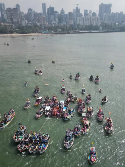 A top-down drone photograph of the boats gathered for Lalbaughcha Raja's Visarjan. This angle provides a unique, almost abstract view of the final rituals.