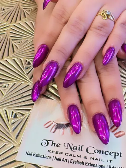 Make a bold statement with these stunning purple chrome nail extensions. The long, almond-shaped nails have a mirror-like finish that catches the light from every angle for a high-impact, futuristic look.
