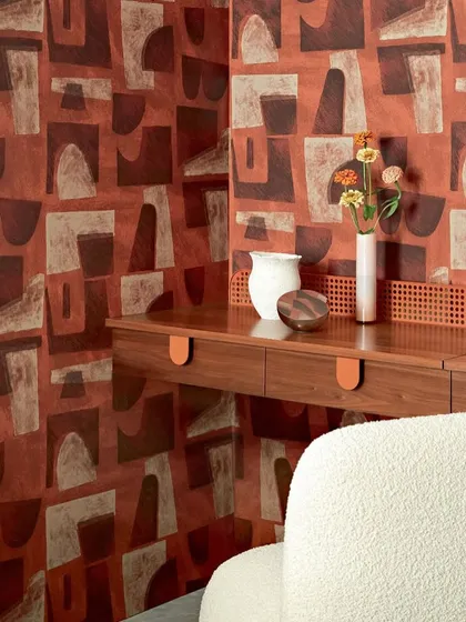 This abstract wallpaper in earthy red tones creates a warm and inviting atmosphere. The overlapping shapes and varied textures add depth and artistic flair, making it a perfect feature wall for a modern space.