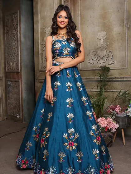A full-length view of this stunning and colorful sangeet outfit. The makeup is designed to balance the vibrant colors of the lehenga perfectly.
