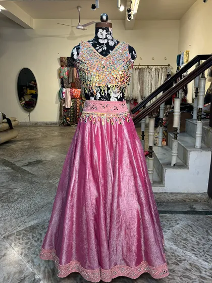 The full view of our mirror work lehenga. The vibrant pink is the new favorite for mehendi functions, a beautiful alternative to traditional yellows and greens.