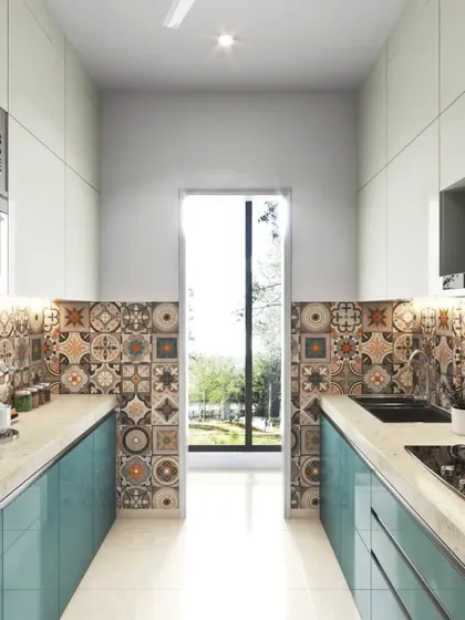We love adding a touch of personality, like in this parallel kitchen featuring a vibrant, patterned tile backsplash. This design element adds a unique desi tadka to the modern setup of teal blue lower cabinets and clean white overheads, creating a truly one-of-a-kind space.